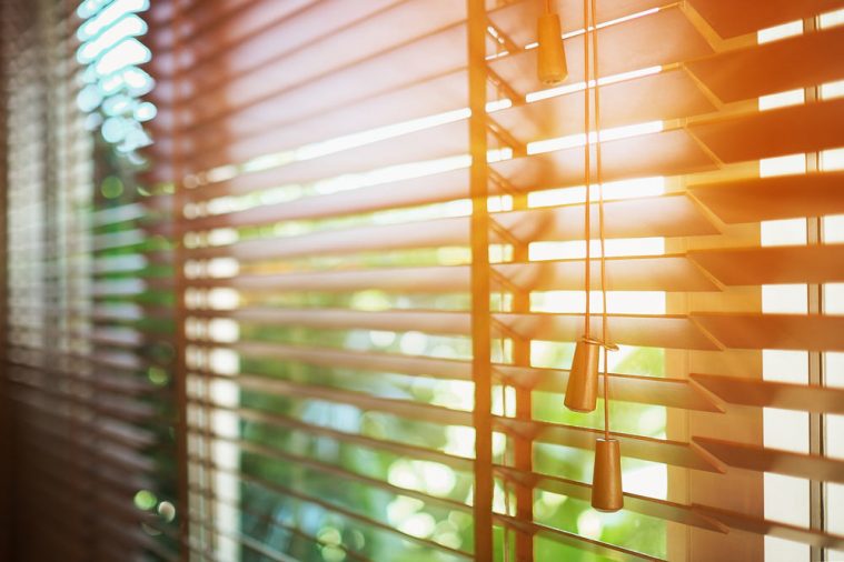 Wooden Blinds With Sun Rays.